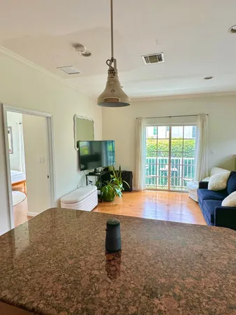 a room with pool table and sofas