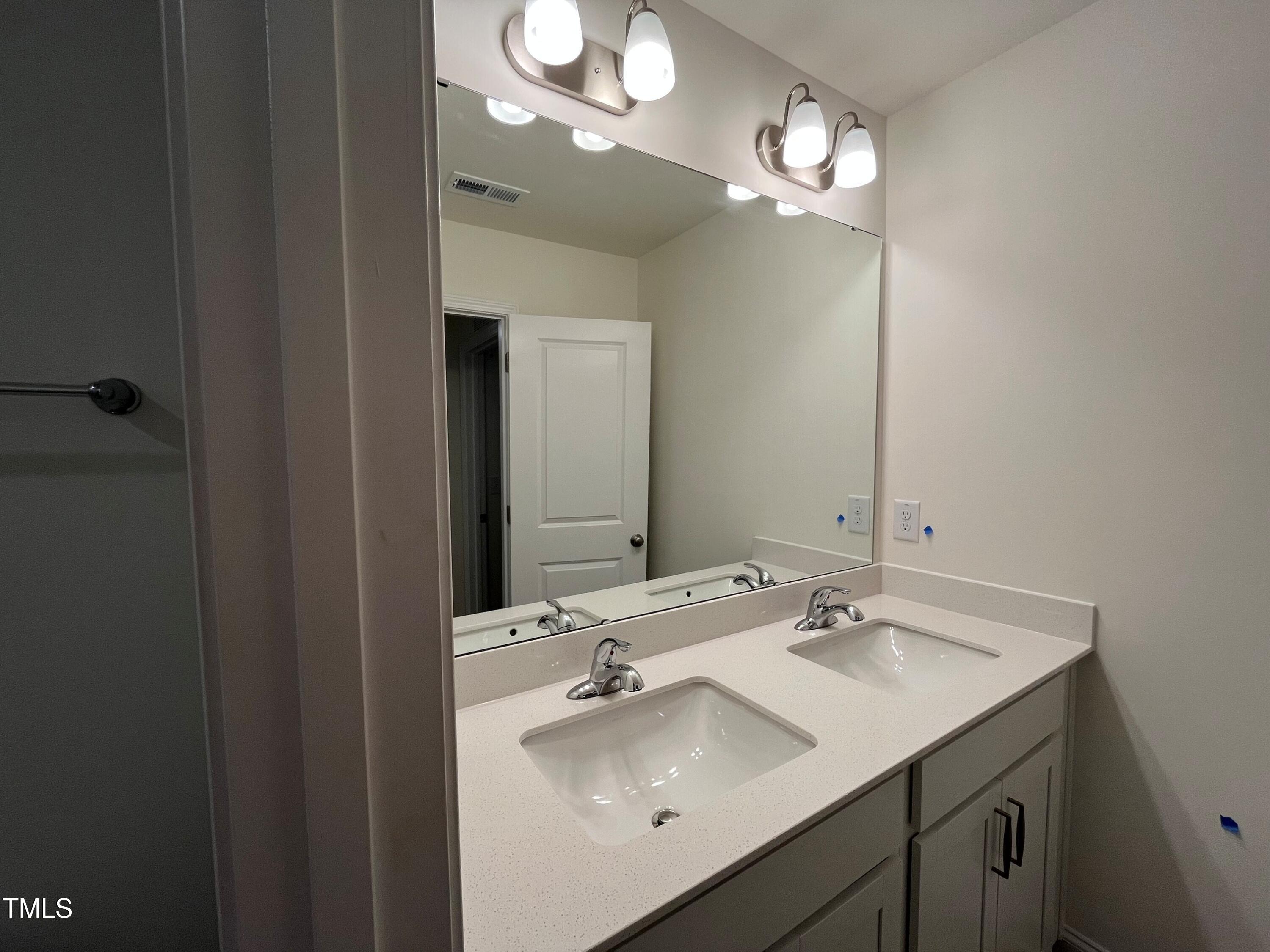 5208 Ranger Grv Way Raleigh, NC 27604 - Photo 36 of 59 a bathroom with a sink and a mirror