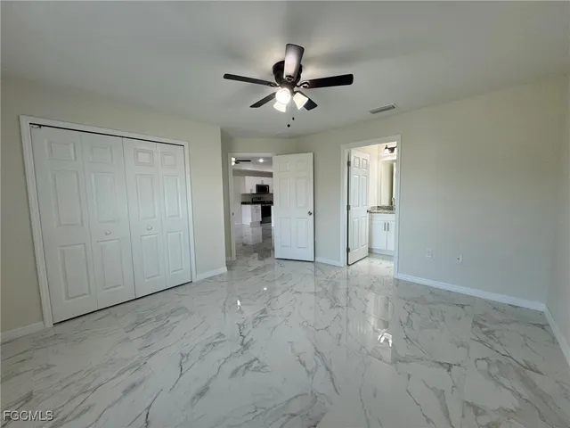 an empty room with fan and a ceiling fan