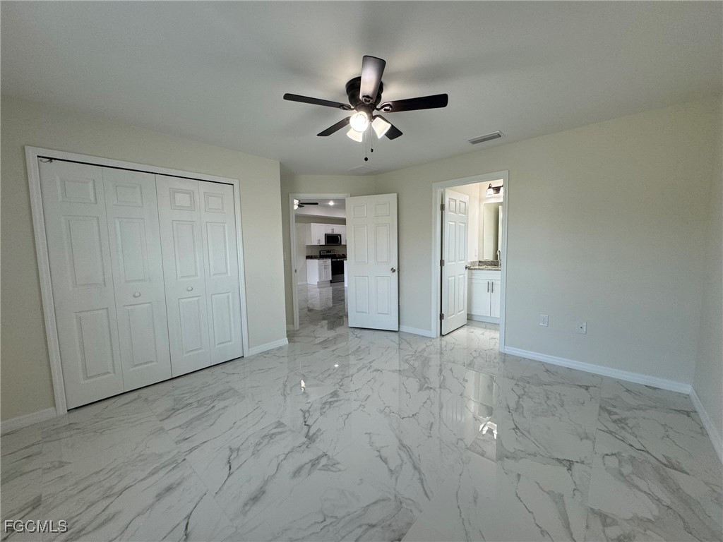884 Alabama Road South Lehigh Acres, FL 33974 - Photo 18 of 37 an empty room with fan and a ceiling fan