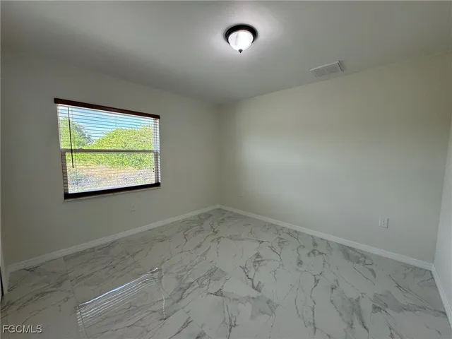 an empty room with windows and closet