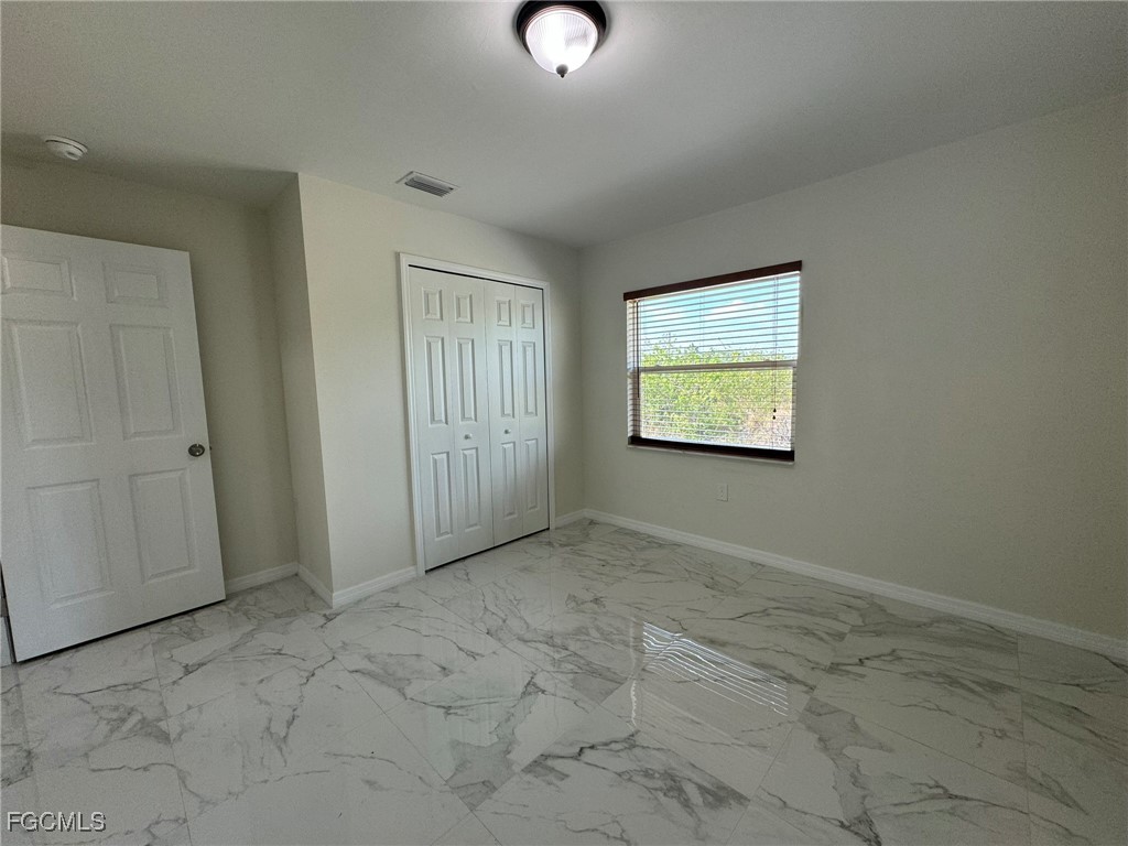884 Alabama Road South Lehigh Acres, FL 33974 - Photo 22 of 37 an empty room with windows and closet
