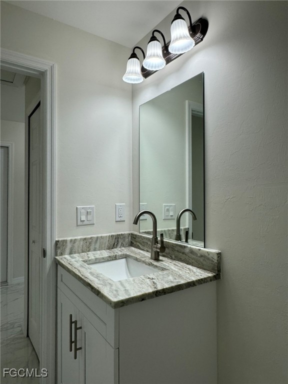 884 Alabama Road South Lehigh Acres, FL 33974 - Photo 25 of 37 a bathroom with a granite countertop sink and a mirror