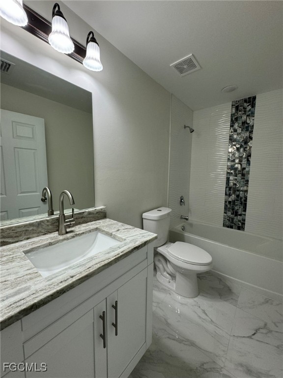 884 Alabama Road South Lehigh Acres, FL 33974 - Photo 26 of 37 a bathroom with a granite countertop toilet sink and mirror