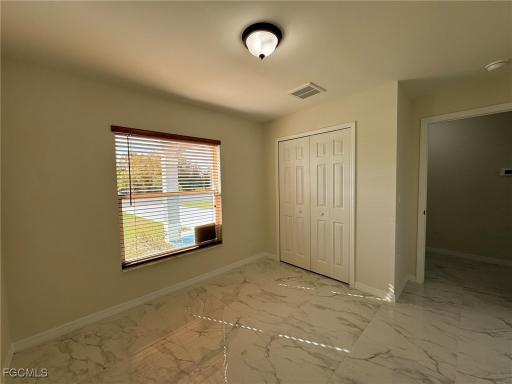 884 Alabama Road South Lehigh Acres, FL 33974 - Photo 28 of 37 an empty room with windows