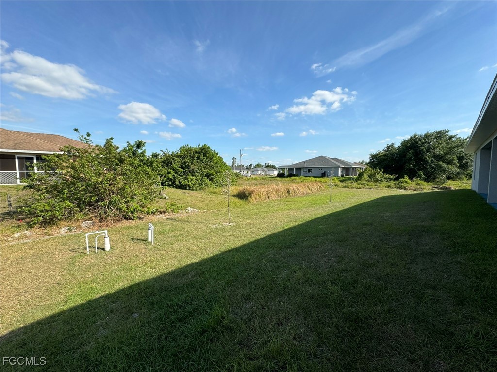884 Alabama Road South Lehigh Acres, FL 33974 - Photo 34 of 37 a view of a golf course with a lake
