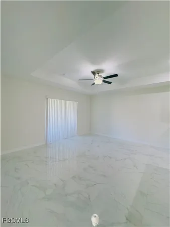 a view of an empty room with a ceiling fan