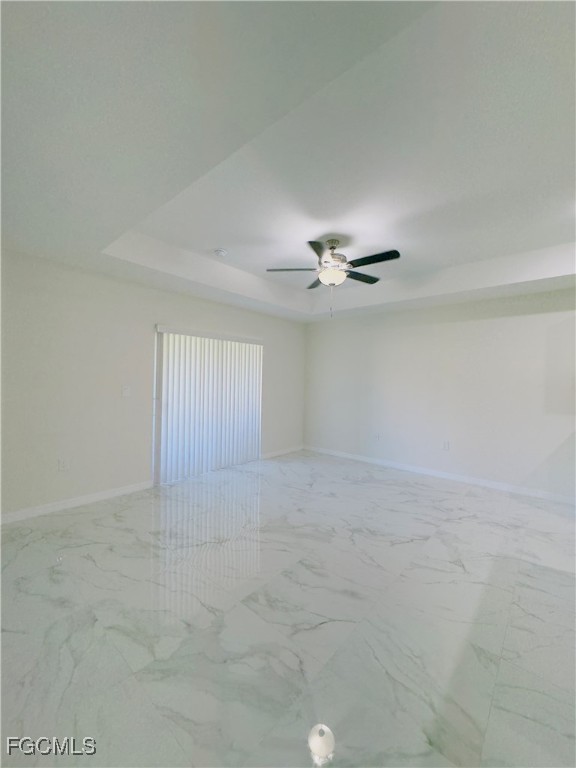 884 Alabama Road South Lehigh Acres, FL 33974 - Photo 6 of 37 a view of an empty room with a ceiling fan
