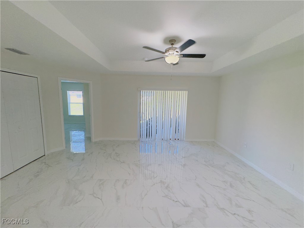 884 Alabama Road South Lehigh Acres, FL 33974 - Photo 7 of 37 a view of an empty room with a window