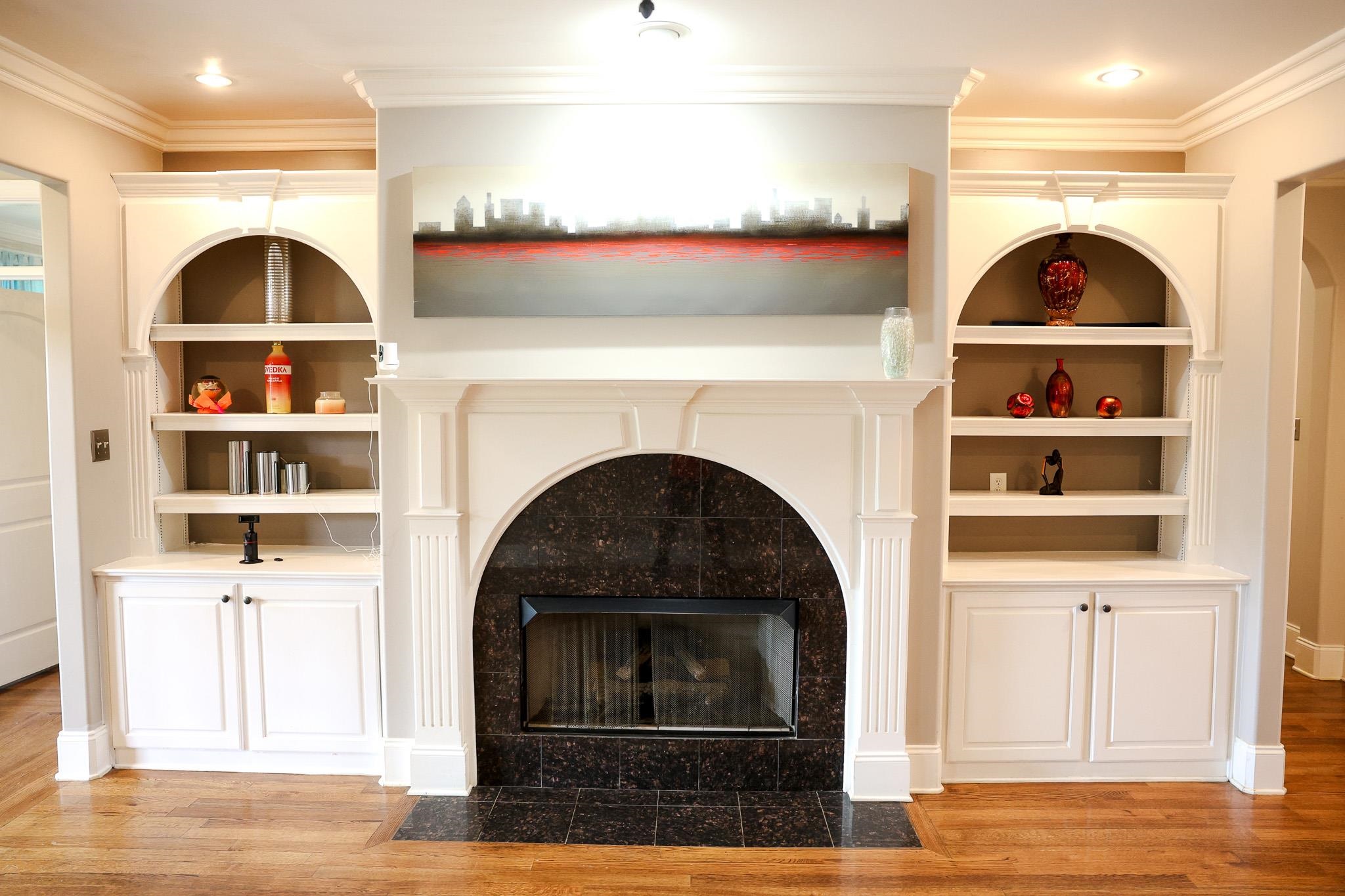 649 Ridge Springs Road Collierville, TN 38017 - Photo 8 of 35 Unfurnished living room with built in shelves, a tiled fireplace, light wood-type flooring, ornamental molding, and recessed lighting