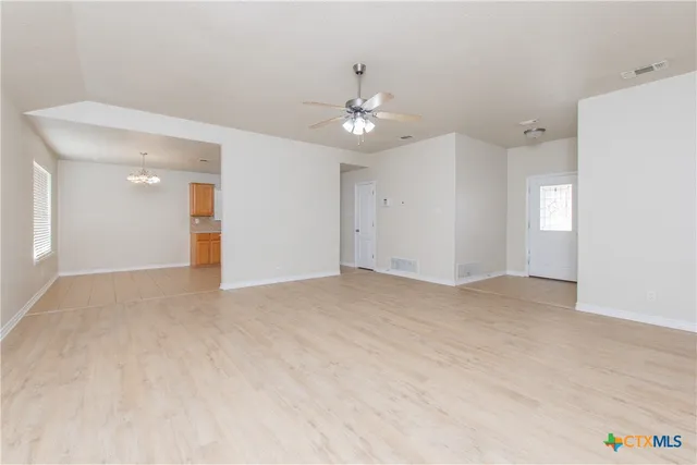 a view of an empty room with a ceiling fan