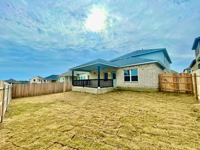 a house view with swimming pool in front of it