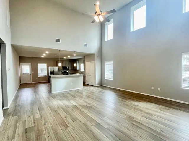 a view of a kitchen with a sink and wooden floor