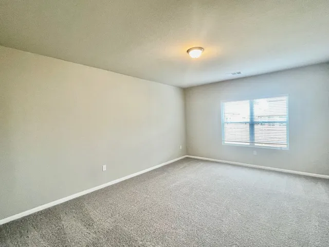 an empty room with a empty space and windows