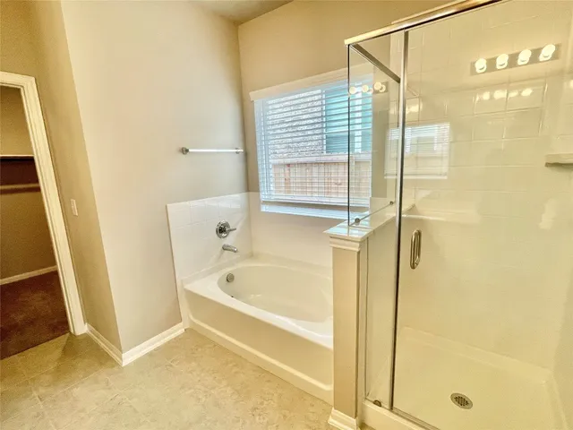 a bathroom with a bathtub and a shower