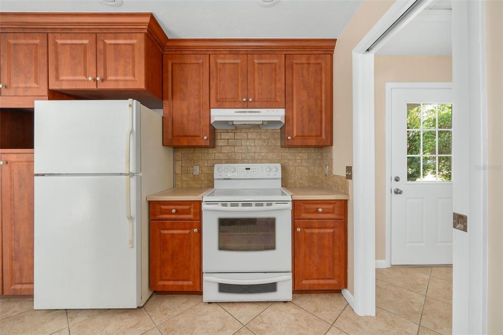 26443 Southwest 3rd Place Newberry, FL 32669 - Photo 13 of 26 a kitchen with stainless steel appliances granite countertop a refrigerator and a stove