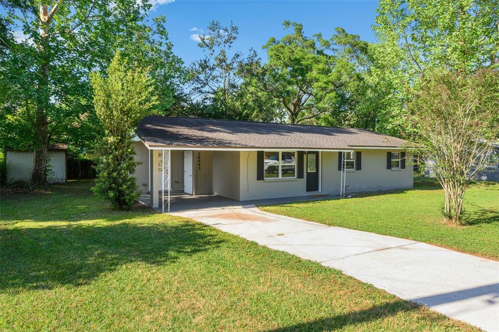 26443 Southwest 3rd Place Newberry, FL 32669 - Photo 2 of 26 front view of a house with a yard