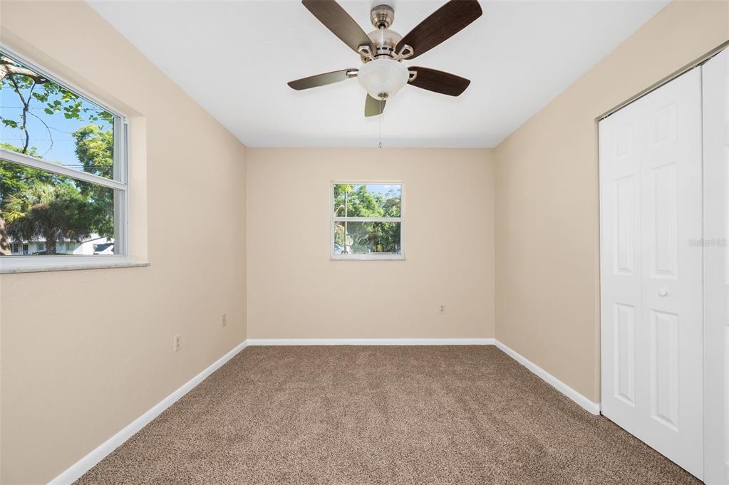 26443 Southwest 3rd Place Newberry, FL 32669 - Photo 22 of 26 an empty room with windows and ceiling fan