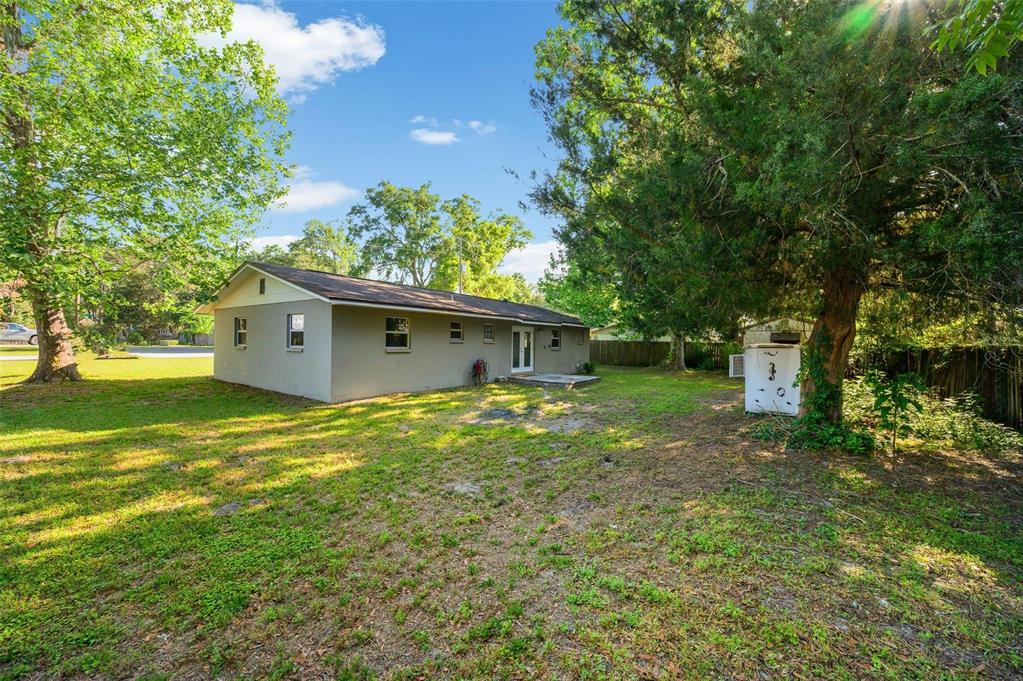 26443 Southwest 3rd Place Newberry, FL 32669 - Photo 24 of 26 a backyard of a house with plants and large trees