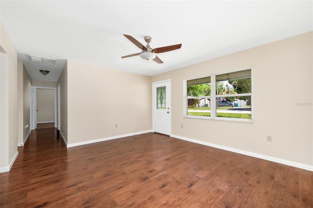 26443 Southwest 3rd Place Newberry, FL 32669 - Photo 6 of 26 a view of an empty room with a window and wooden floor