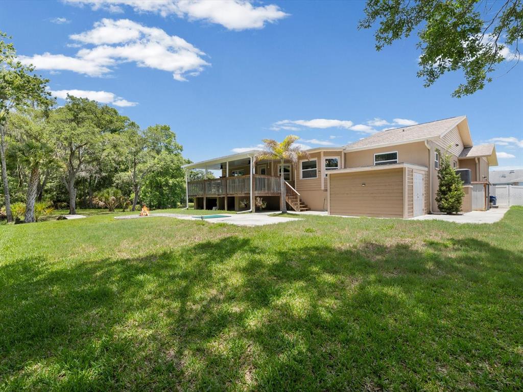 5904 Springrun Court Holiday, FL 34690 - Photo 40 of 53 a view of a house with a backyard