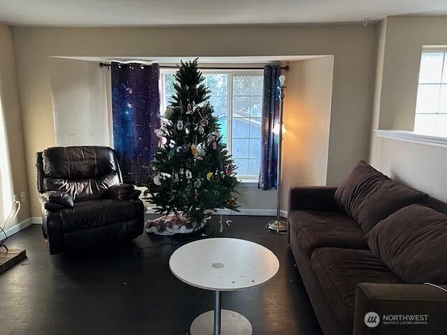 a living room with furniture a window and a potted plant