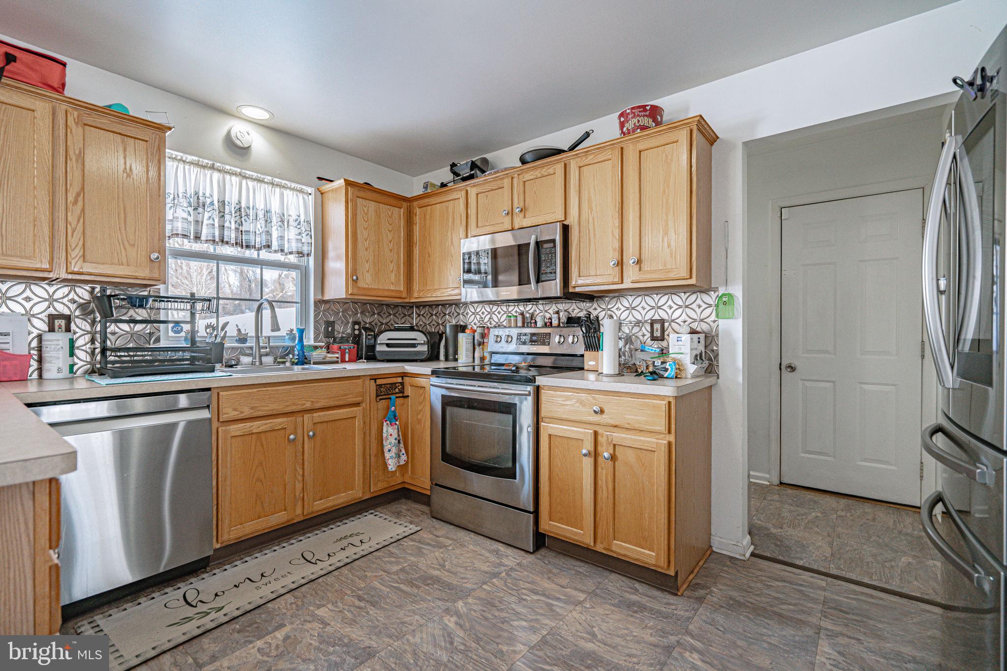 35 Ridgeview Drive Lehighton, PA 18235 - Photo 13 of 58 a kitchen with stainless steel appliances granite countertop a stove a sink dishwasher a refrigerator and cabinets with wooden floor
