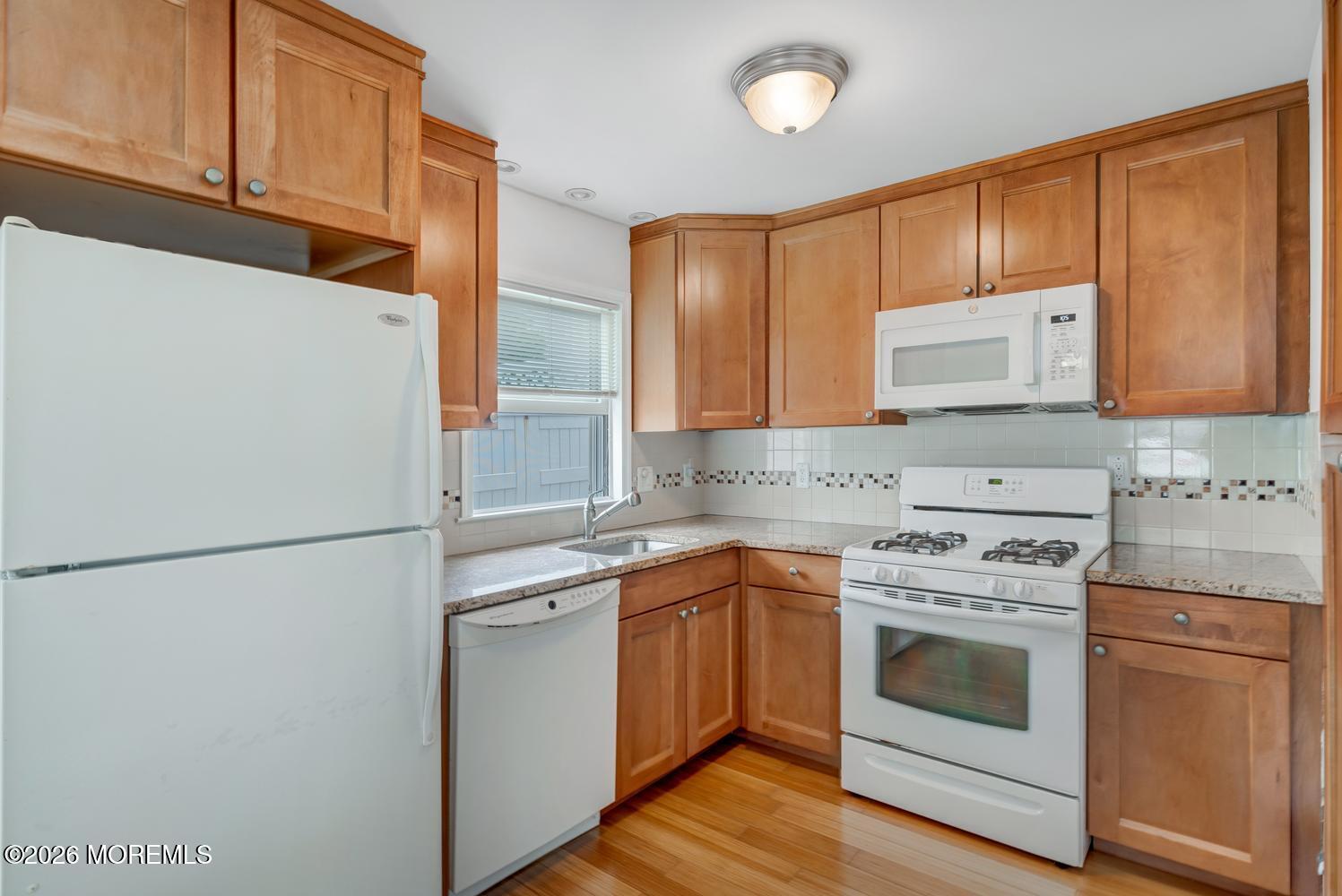 19 Shore Way Lavallette, NJ 08735 - Photo 14 of 38 a kitchen with a stove top oven sink and refrigerator