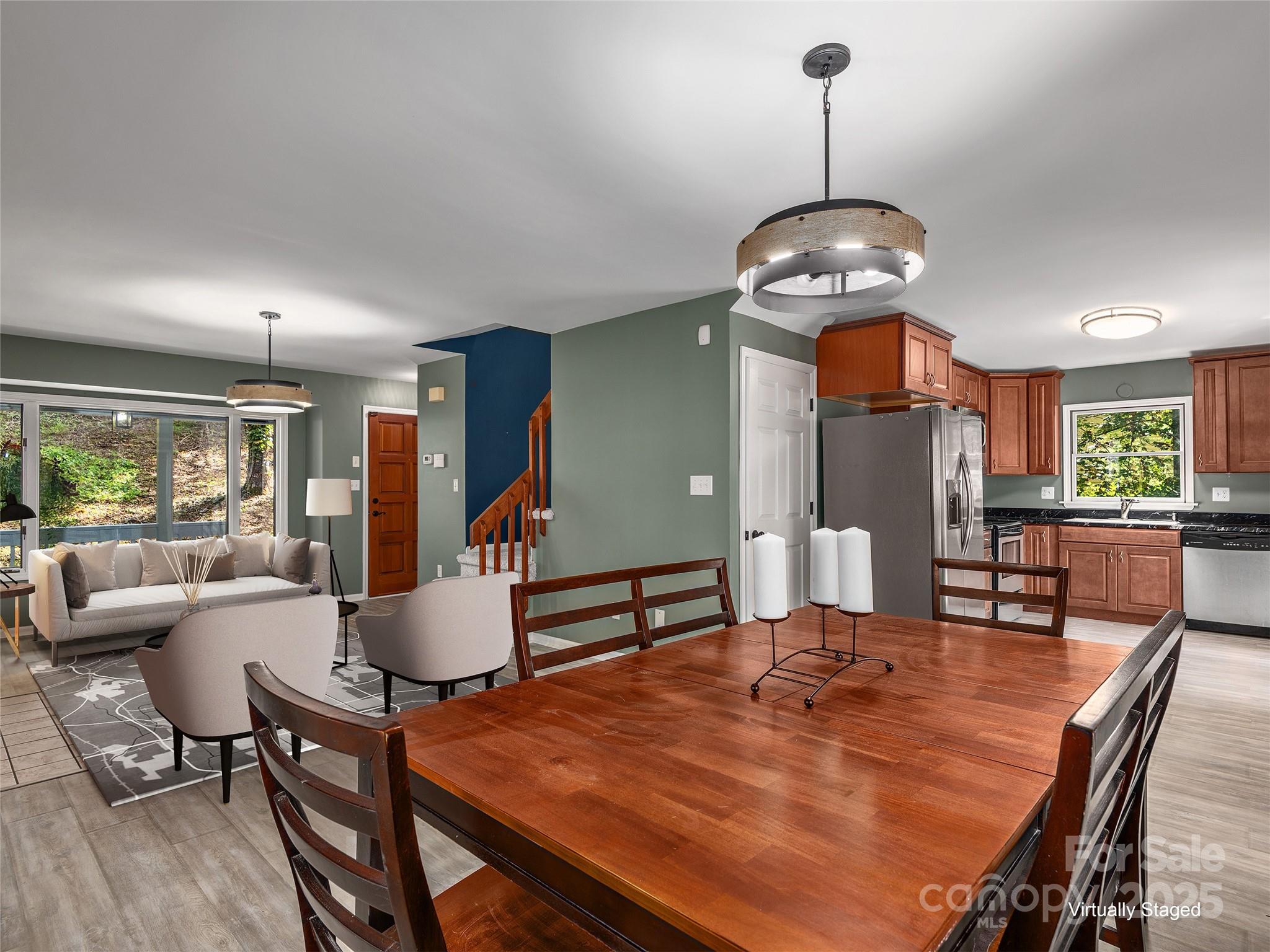 66 High Country Road Weaverville, NC 28787 - Photo 11 of 36 a dining room with wooden floor a chandelier a glass table and chairs