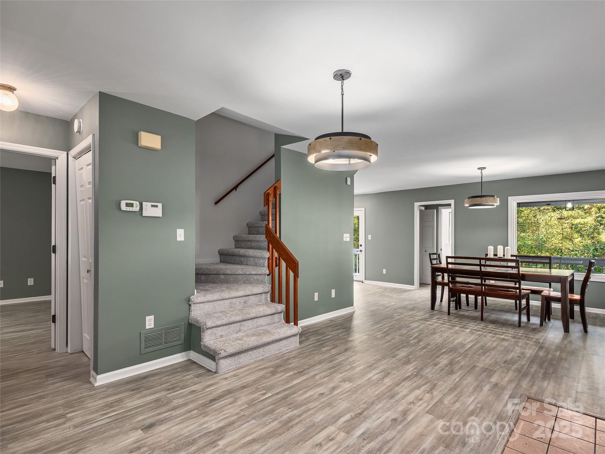 66 High Country Road Weaverville, NC 28787 - Photo 13 of 36 a view of a livingroom with furniture wooden floor and staircase