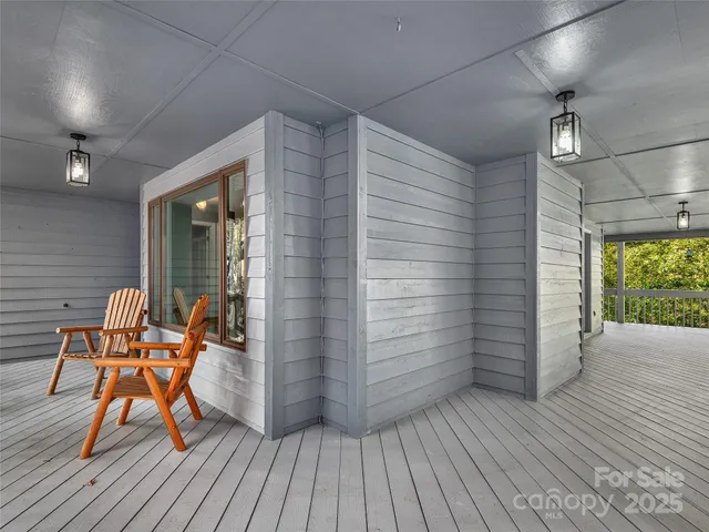 a view of a room with wooden floor and furniture