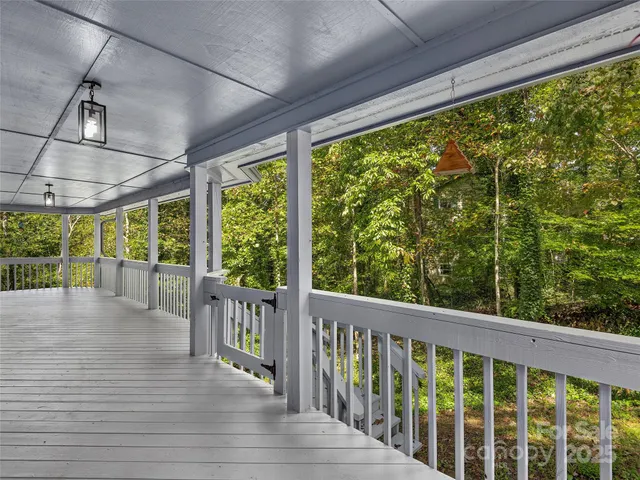 a view of porch with a floor to ceiling window and wooden floor