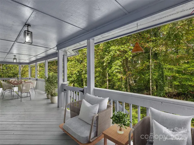 a balcony with furniture and wooden floor
