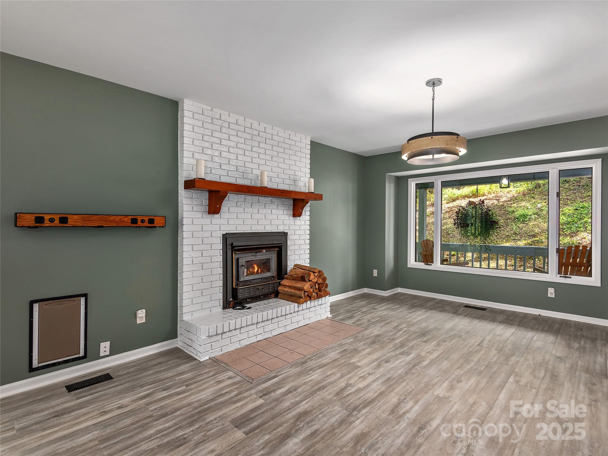 66 High Country Road Weaverville, NC 28787 - Photo 7 of 36 a bedroom with a bed and a fireplace