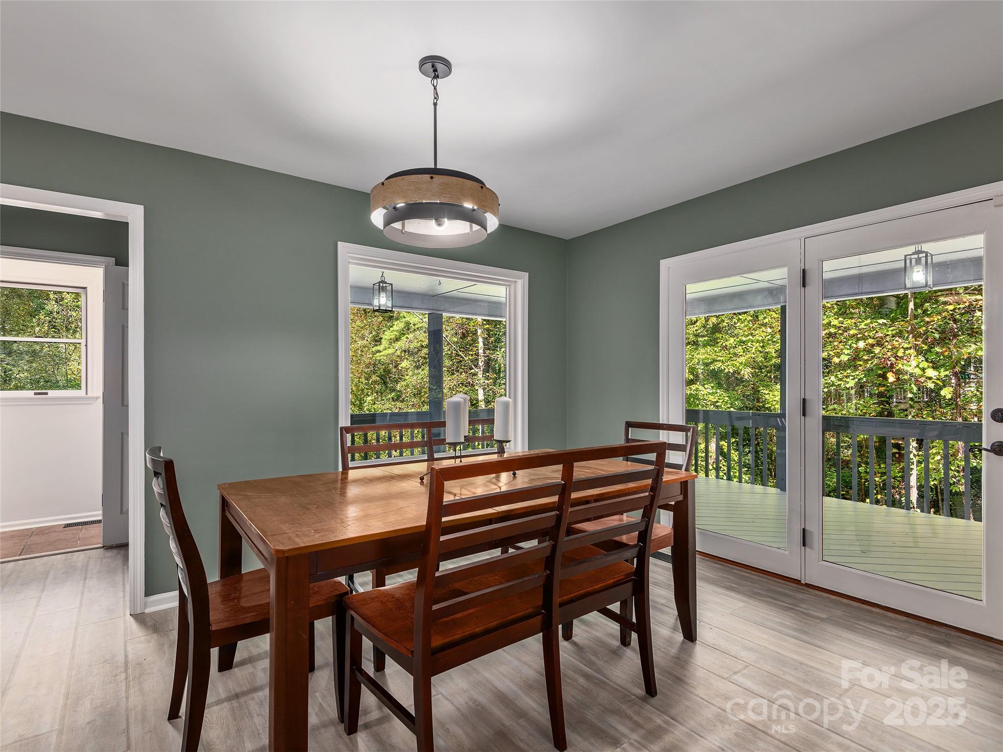 66 High Country Road Weaverville, NC 28787 - Photo 9 of 36 a view of a dining room with furniture window and wooden floor