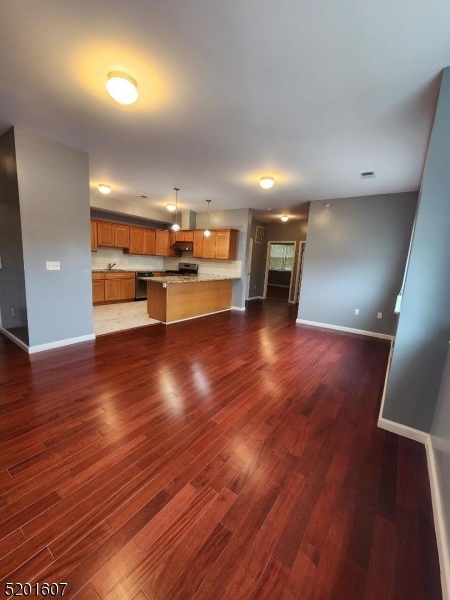 25 Cottage Street, Unit 7 Newark, NJ 07102 - Photo 2 of 5 an empty room with wooden floor and entrance
