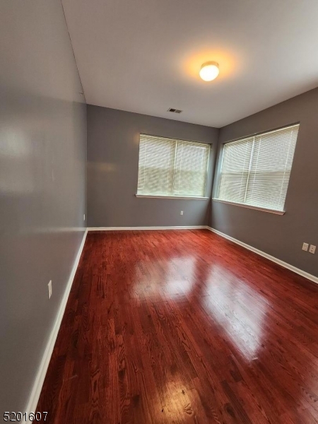 25 Cottage Street, Unit 7 Newark, NJ 07102 - Photo 5 of 5 an empty room with wooden floor and windows