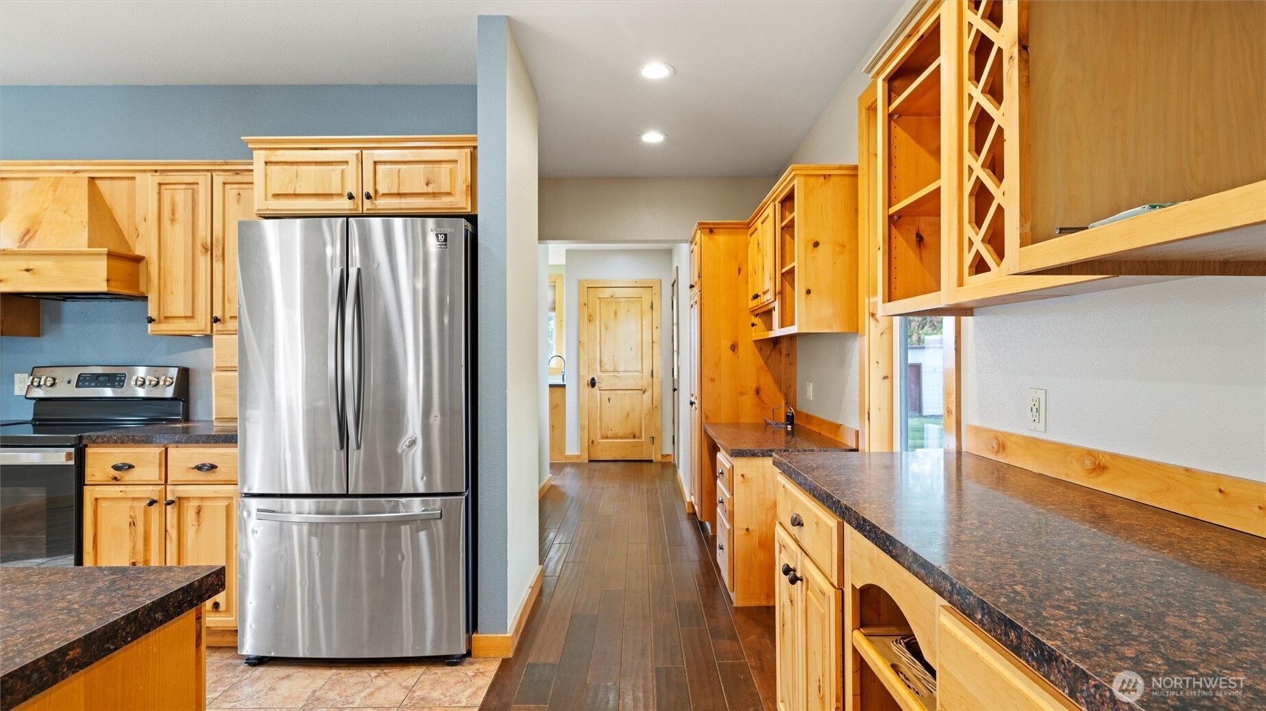 109 Cold Spring Lane Dayton, WA 99328 - Photo 12 of 40 a kitchen with stainless steel appliances granite countertop a refrigerator a stove and a sink with wooden floor