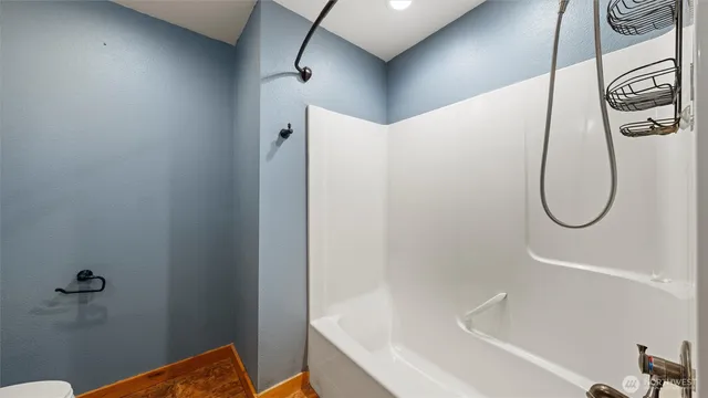 a bathroom with a shower and a window