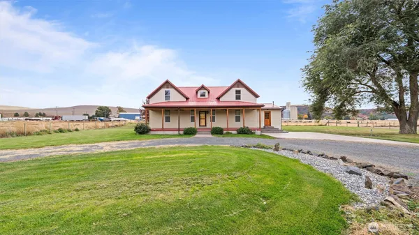 a front view of house with yard and outdoor seating