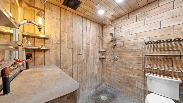 a bathroom with a sink a mirror and a shower