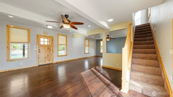 a view of an entryway with wooden floor
