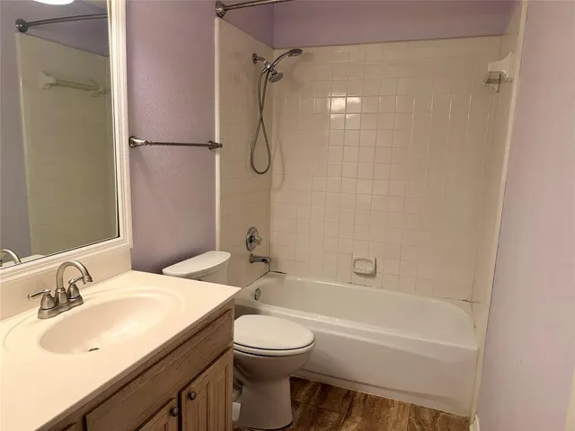 a bathroom with a sink toilet vanity and shower