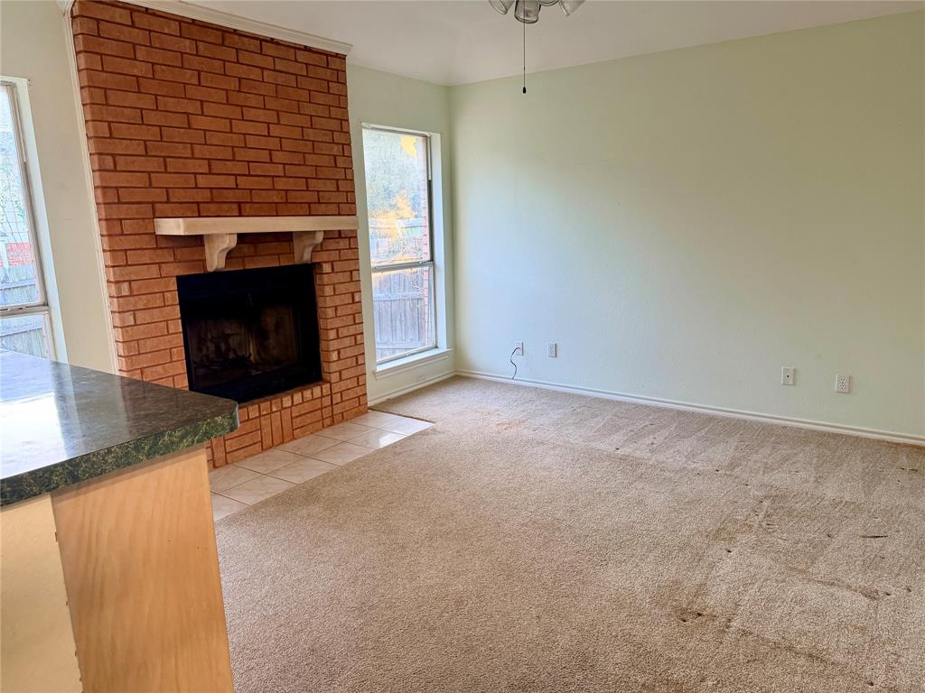 7632 Arbor Ridge Court Fort Worth, TX 76112 - Photo 7 of 19 a view of empty room with a fireplace
