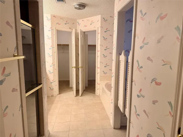 a view of a bathroom with a shower and a door