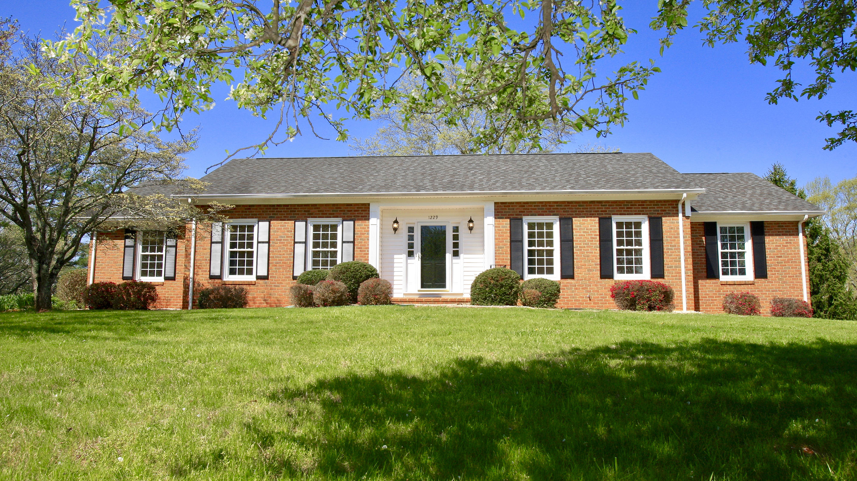 1229 Trails End Road Goodview, VA 24095 - Photo 3 of 106 a front view of a house with a yard and green space