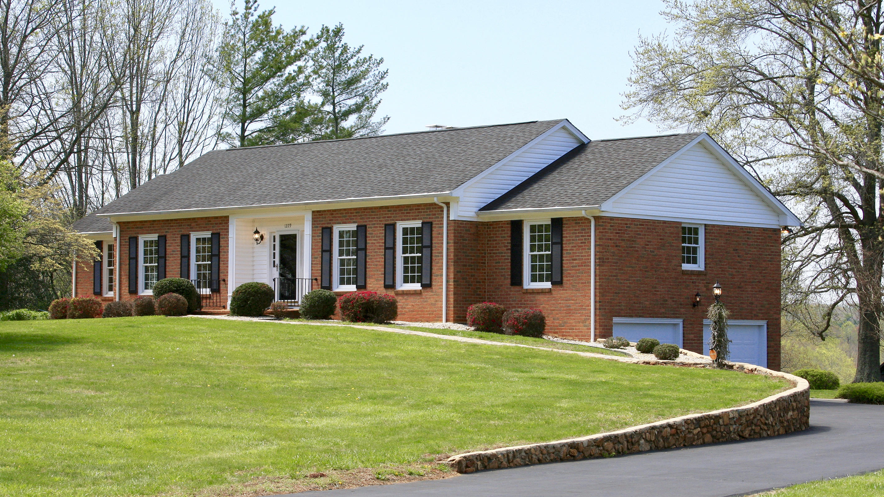 1229 Trails End Road Goodview, VA 24095 - Photo 28 of 106 a front view of a house with a yard and garage