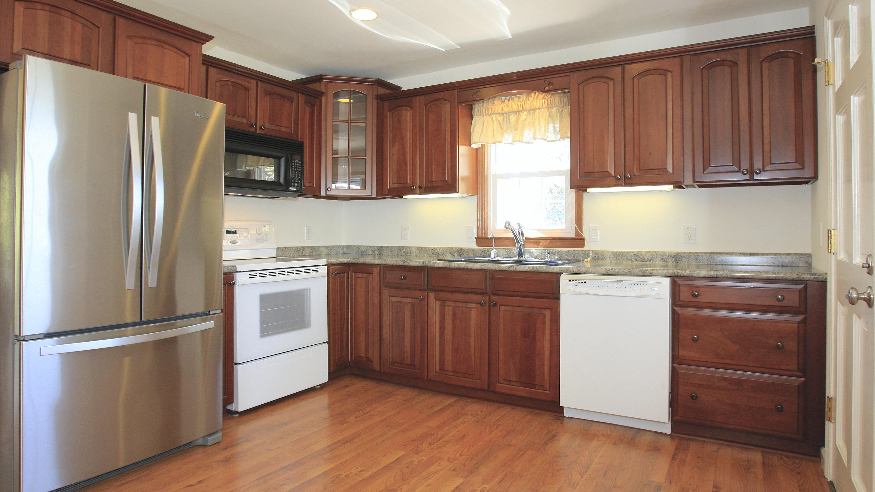 1229 Trails End Road Goodview, VA 24095 - Photo 36 of 106 a kitchen with granite countertop stainless steel appliances a refrigerator cabinets and wooden floor