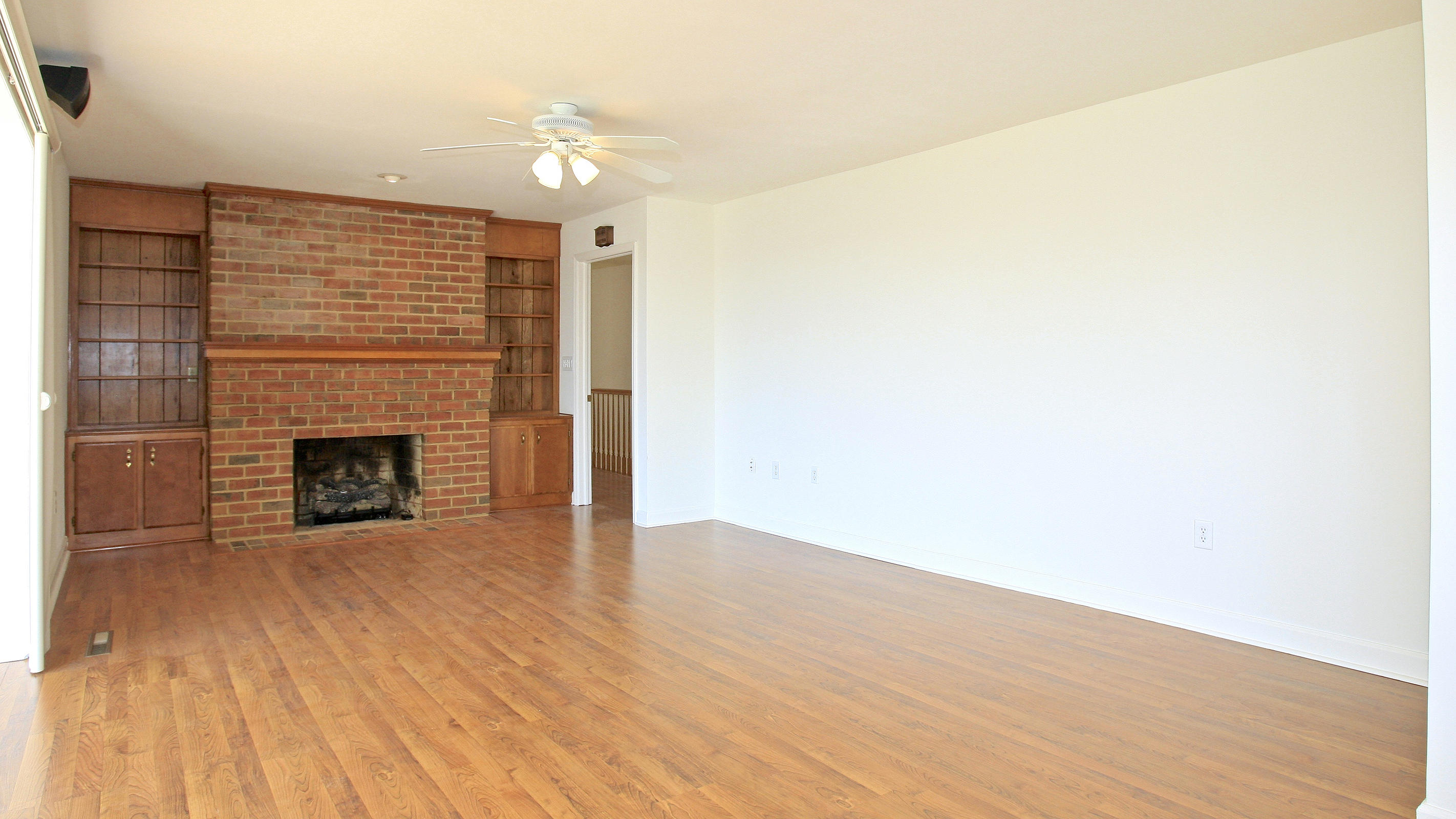 1229 Trails End Road Goodview, VA 24095 - Photo 40 of 106 a view of an empty room with wooden floor and a fireplace