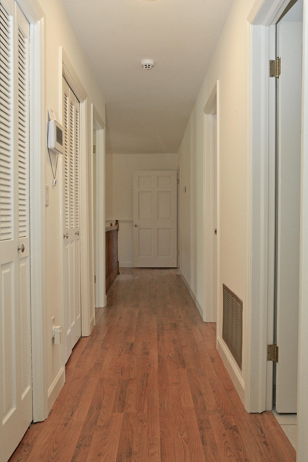 1229 Trails End Road Goodview, VA 24095 - Photo 45 of 106 a view of a hallway with wooden floor and a bathroom
